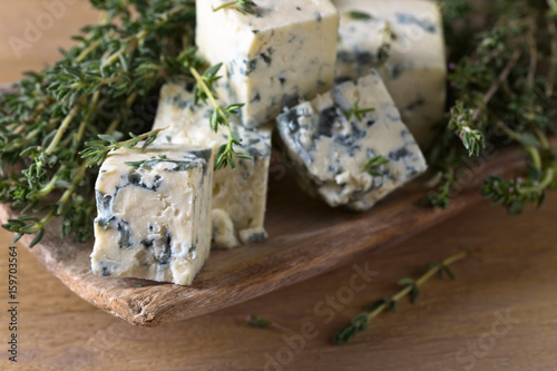 Blue cheese on a wooden table .