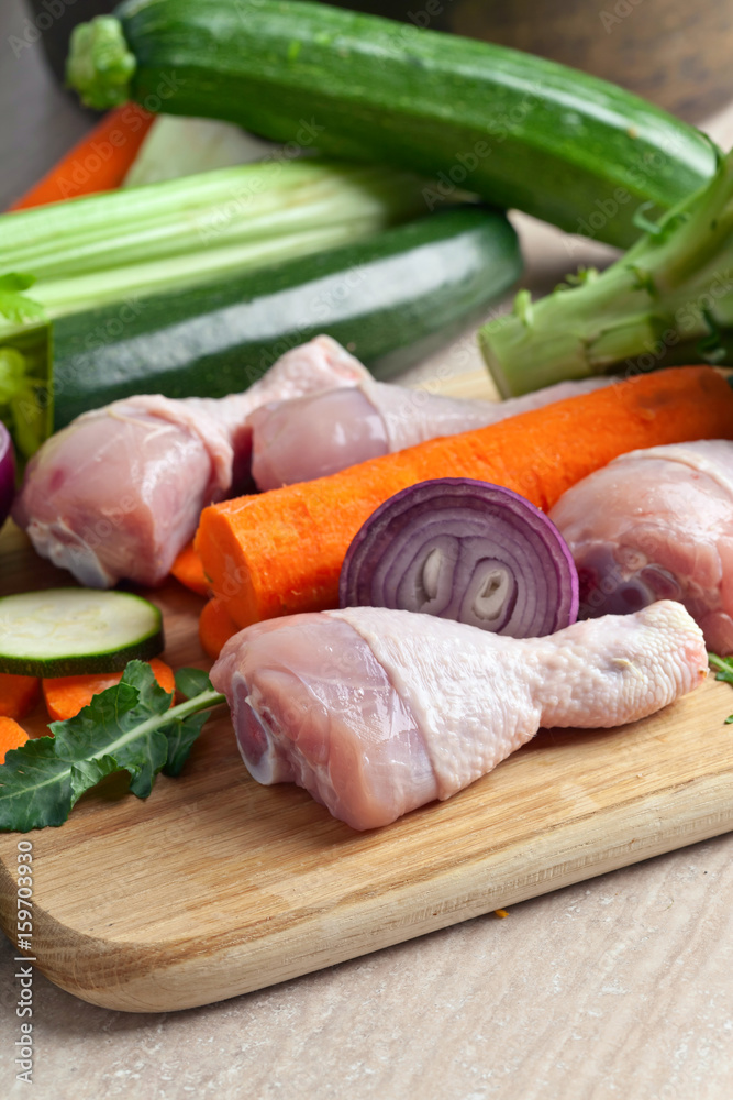 Close-up of chicken drumsticks with  vegetables