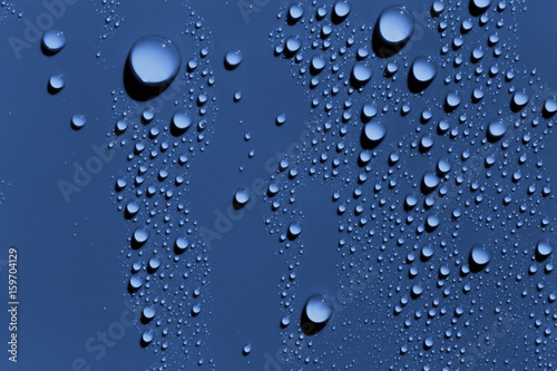 Raindrops on blue surface  background