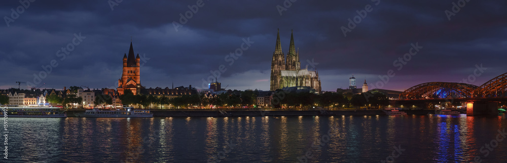 Panorama of the old evening Cologne. Rhine, railway bridge