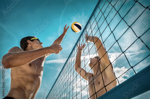 Beach Volleyball players in sunglasses under sunlight. Dynamic s