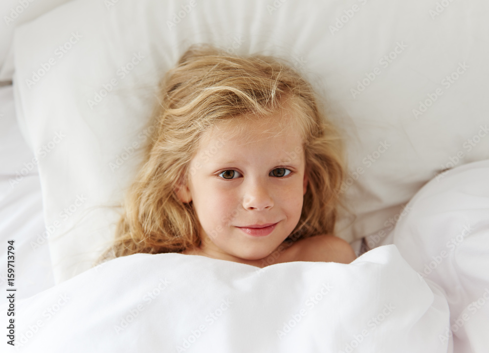 Lovely girl waking up in comfortable bed at home in the morning. Lovely girl waking up in comfortable bed at home in the morning.