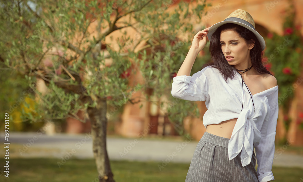 Naklejka premium Beautiful woman resting in the summer the Italian garden
