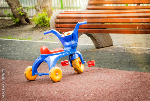 Abandoned colorful plastic children's tricycle on the Playground