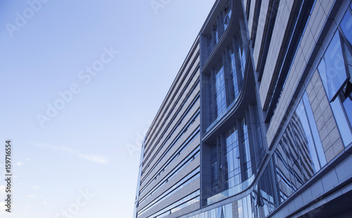 Modern glass building under the blue sky