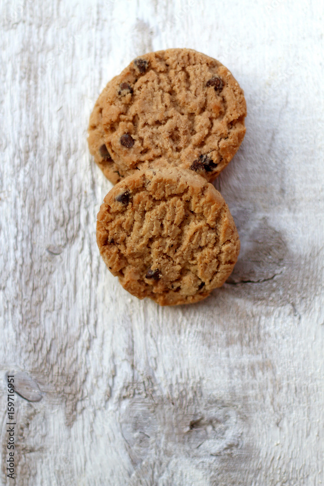Fototapeta premium Chocolate chip cookies on white rustic table. Selective focus.