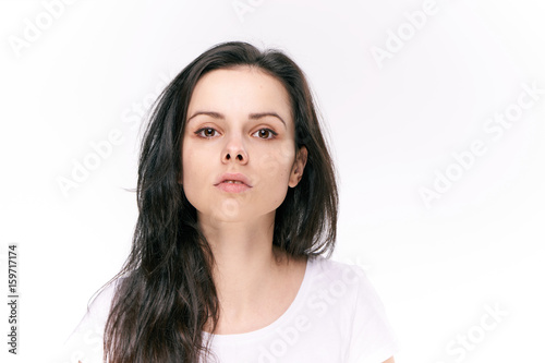 Serious woman with her hair on the isolated background portrait