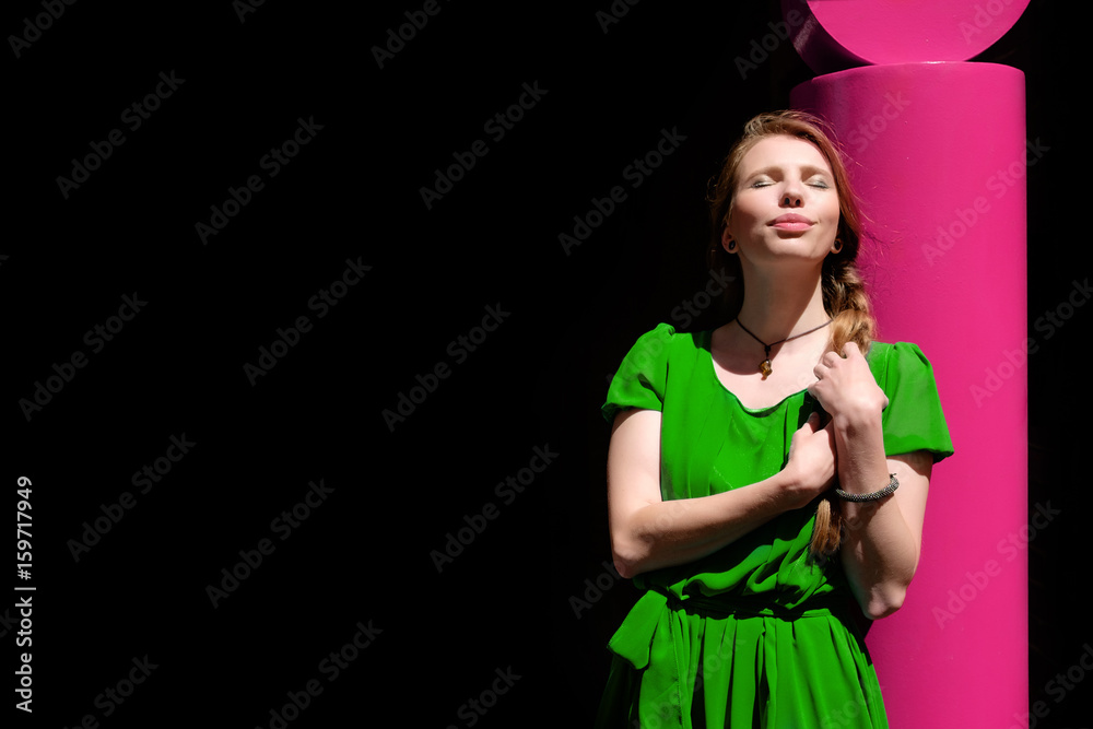 young pretty woman in blue dress basking in the sun with closed eyes, copy space young pretty woman in blue dress basking in the sun with closed eyes, copy space