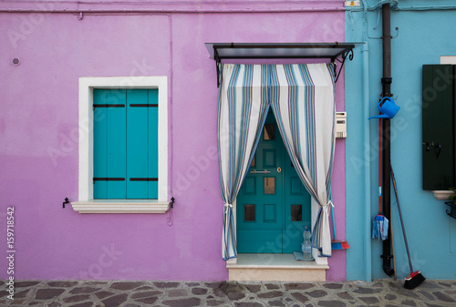 Colourful buildings lining cannal, Island of Burano, Venice Italy photo