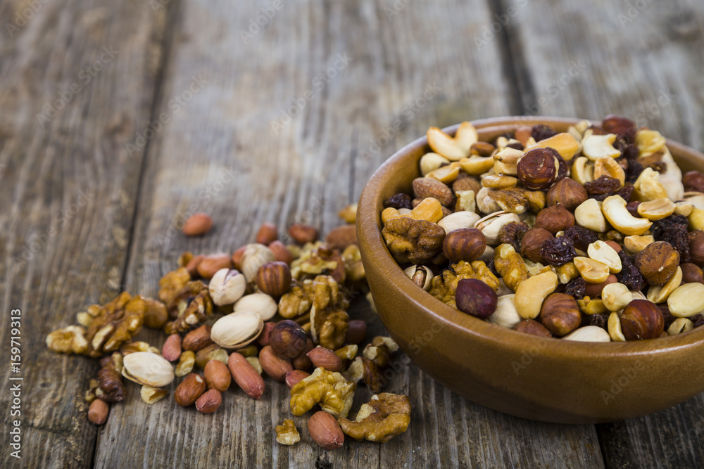 Nuts in a wooden bowl  on a  wooden table