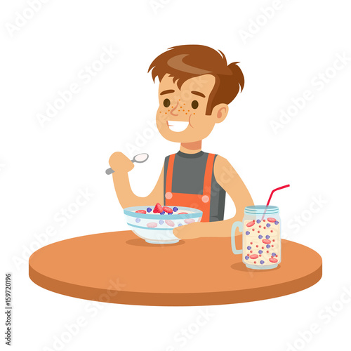 Cute smiling boy having breakfast in the kitchen, colorful character vector Illustration