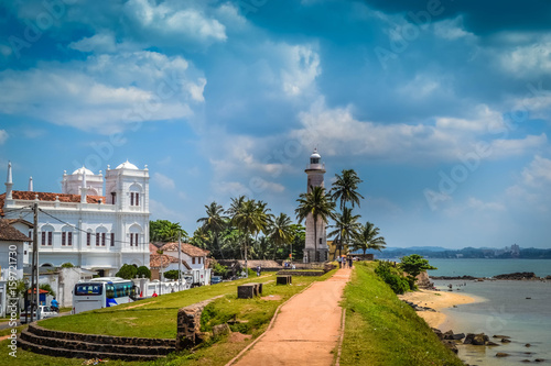 White Lighthouse on the shore in Galle Sri Lanka photo