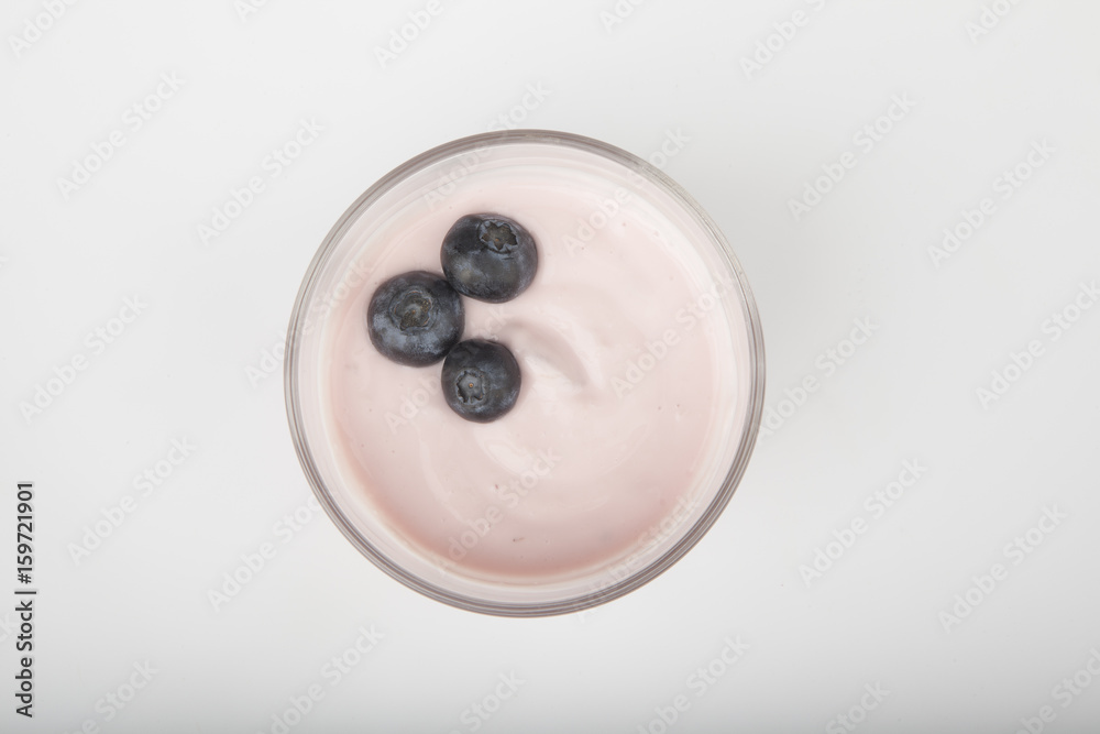 glass of fresh berries and yogurt isolated on white background glass of fresh berries and yogurt isolated on white background
