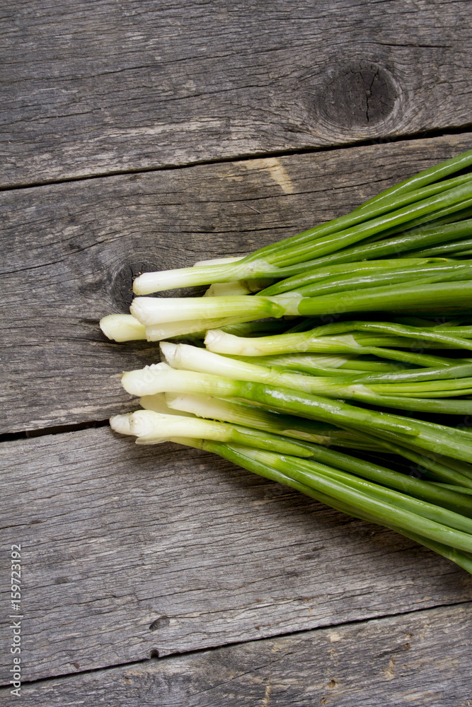 green onions on wooden background green onions on wooden background