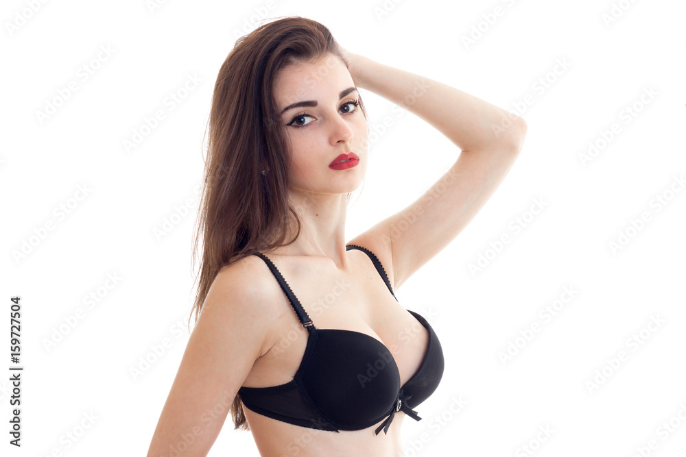 woman with red lips with big natural boobs in black bra looks at camera  Stock Photo