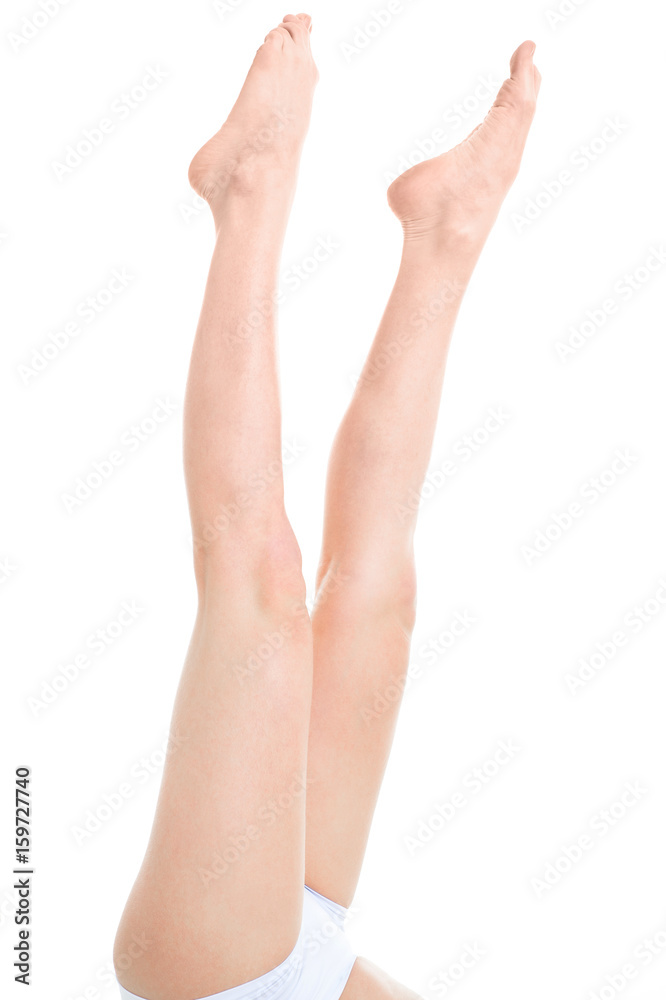 Slender legs of a young woman isolated on white background Slender legs of a young woman isolated on white background