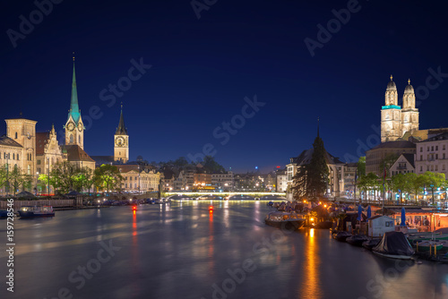 Panoramic view of historic Zurich city center with famous Fraumunster Church and river Limmat at Lake Zurich , in twilight, Canton of Zurich, Switzerland.