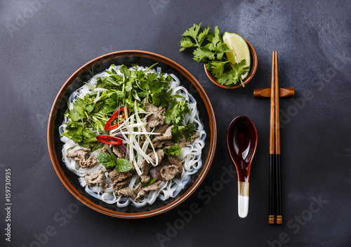 Pho Bo vietnamese Soup with beef on dark background