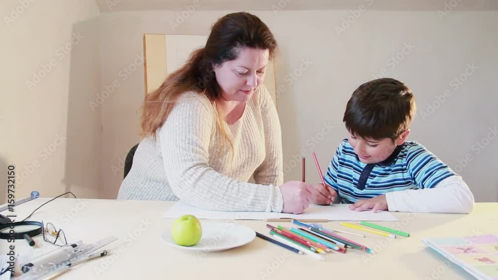 Mother and child draw together in the album Mother and child draw together in the album