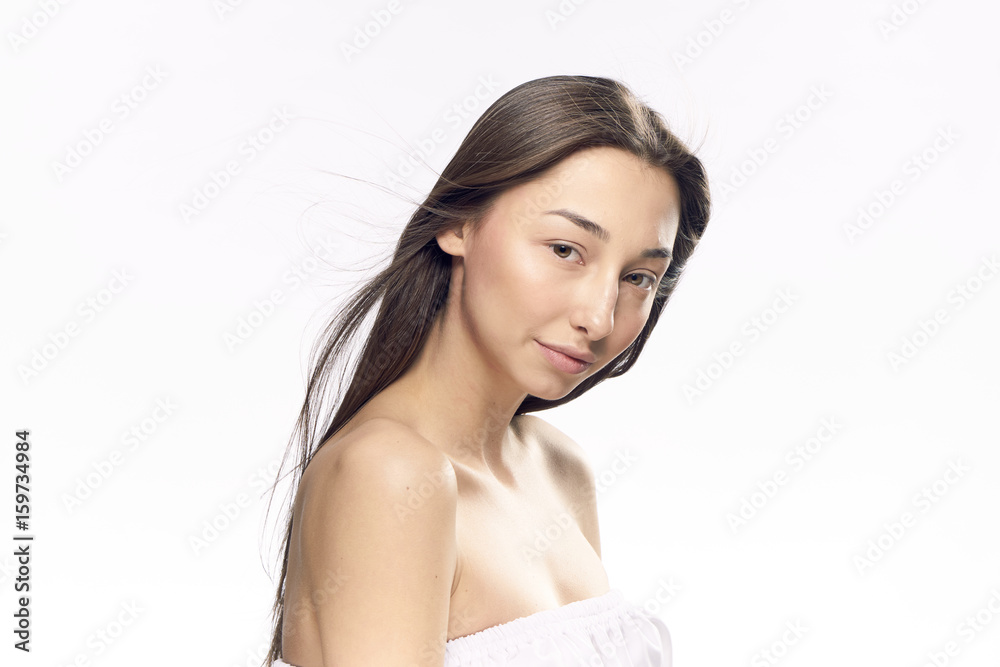 Woman with a well-groomed face on a light background portrait