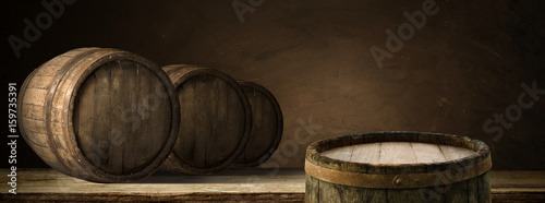 corkscrew and wooden barrel, vineyard on background photo