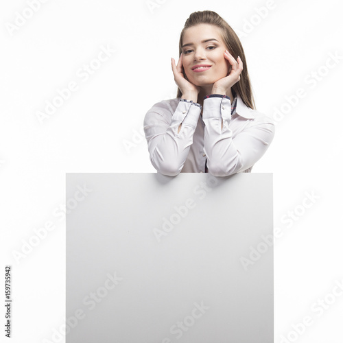 Young happy woman showing presentation, pointing on placard over