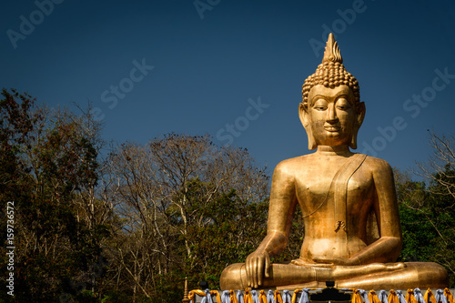 Golden Buddha statue in Buddhist  temple or wat  is public domain or treasure of Buddhism.  Shot at outdoor  public area 