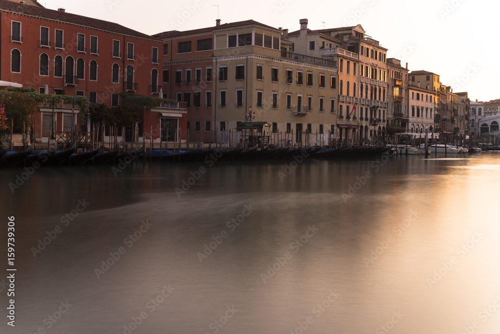 View onto the Canal Grande and the Rialto bridge in Venice at sunrise.