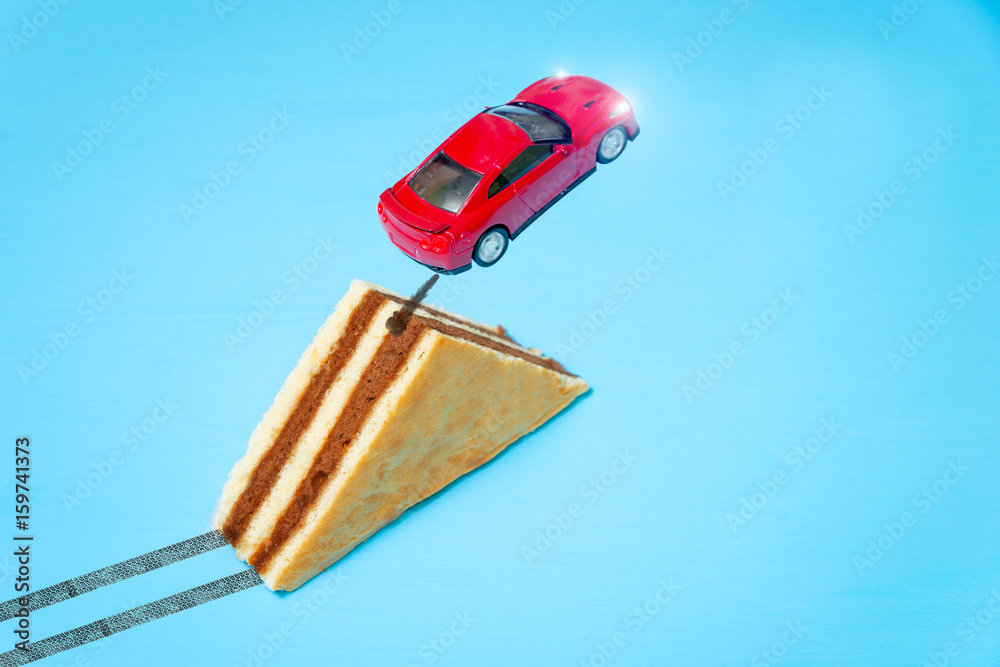toy car jumping from the springboard in the form of a cake
