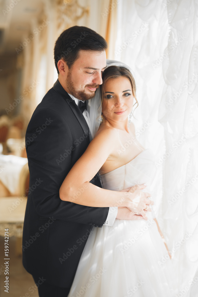 Wedding photo shoot of the newlyweds couple posing in a beautiful hotel