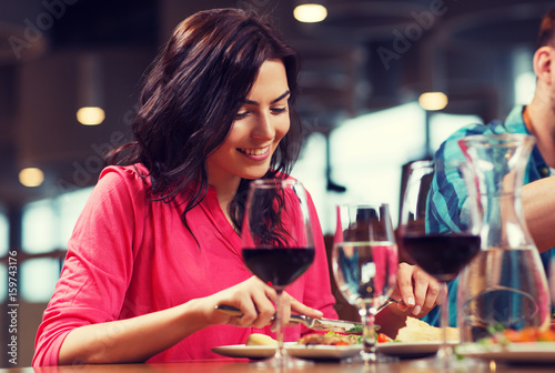 happy woman having dinner at restaurant