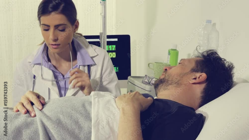 Man in hospital almost crying scared about disease talking with female doctor dolly shot Man in hospital almost crying scared about disease talking with female doctor dolly shot