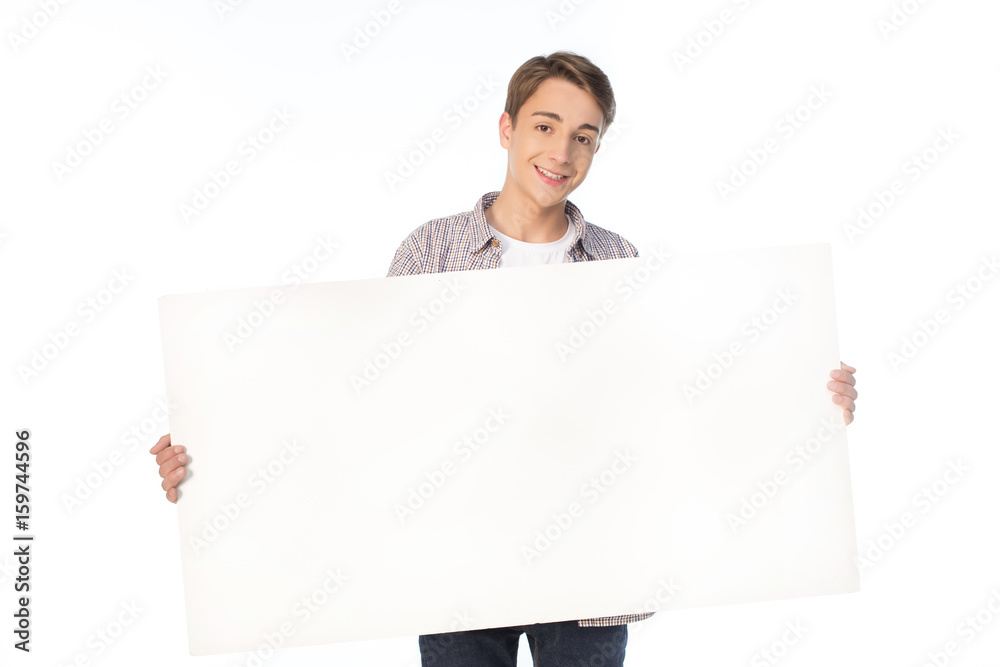 smiling teenage boy holding blank banner isolated on white smiling teenage boy holding blank banner isolated on white
