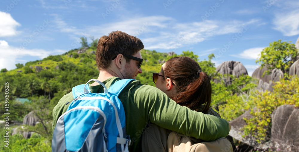 happy couple with backpacks traveling