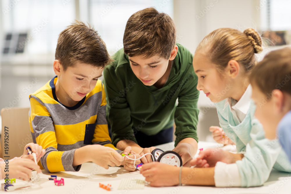 happy children building robots at robotics school happy children building robots at robotics school