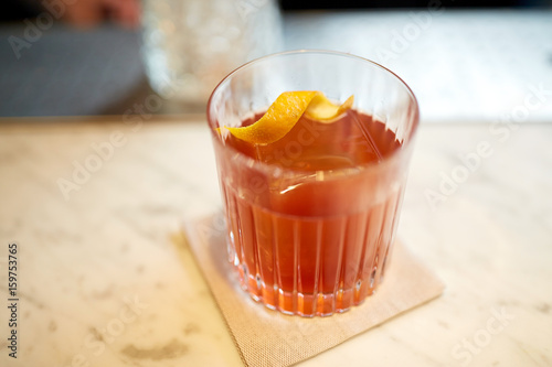 Fototapeta glass of alcohol cocktail on bar counter