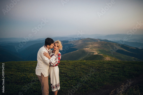 happy couple posing at mountains