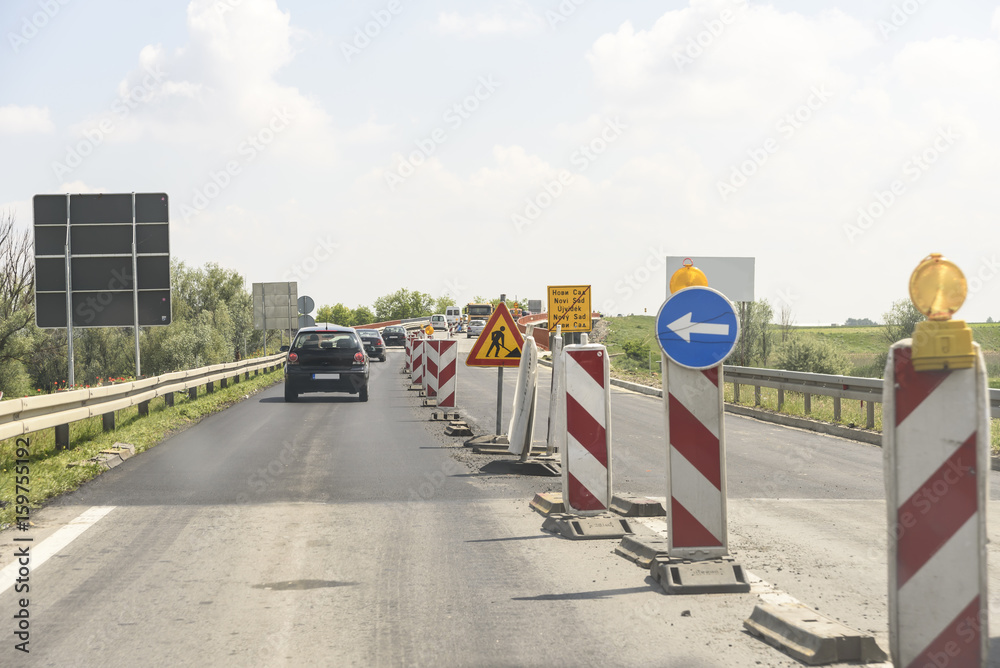 Column flow of vehicles on the road works on the bridge Column flow of vehicles on the road works on the bridge