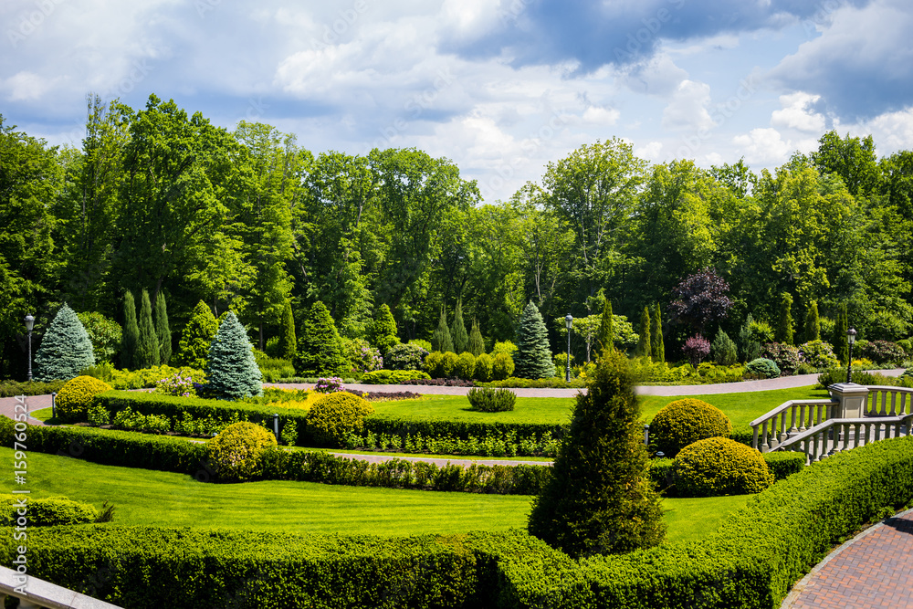 Landscaping in the garden. The path in the garden.Beautiful backyard landscape design,Some flowers and nicely trimmed bushes on the leveled front yard,Landscape formal