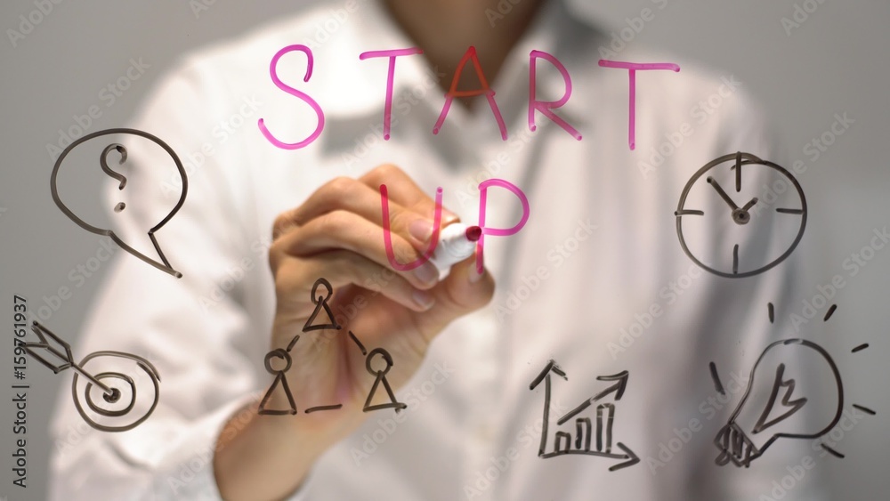 Start Up concept. Woman writing and drawing on transparent screen. Businesswoman write on board Start Up concept. Woman writing and drawing on transparent screen. Businesswoman write on board