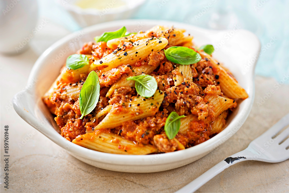 Italian tuscan sausage penne in tomato sauce with basil  - obrazy, fototapety, plakaty 