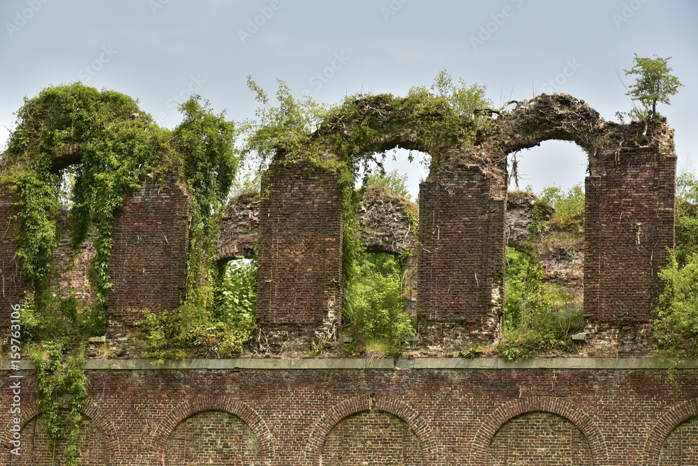 Les ruines en briques rouges du château de Charles de Lorraine couvertes de végétation au printemps au domaine de Mariemont à Morlanwelz 