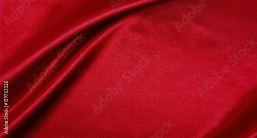 Smooth elegant red silk or satin luxury cloth texture as abstract background. Luxurious background design