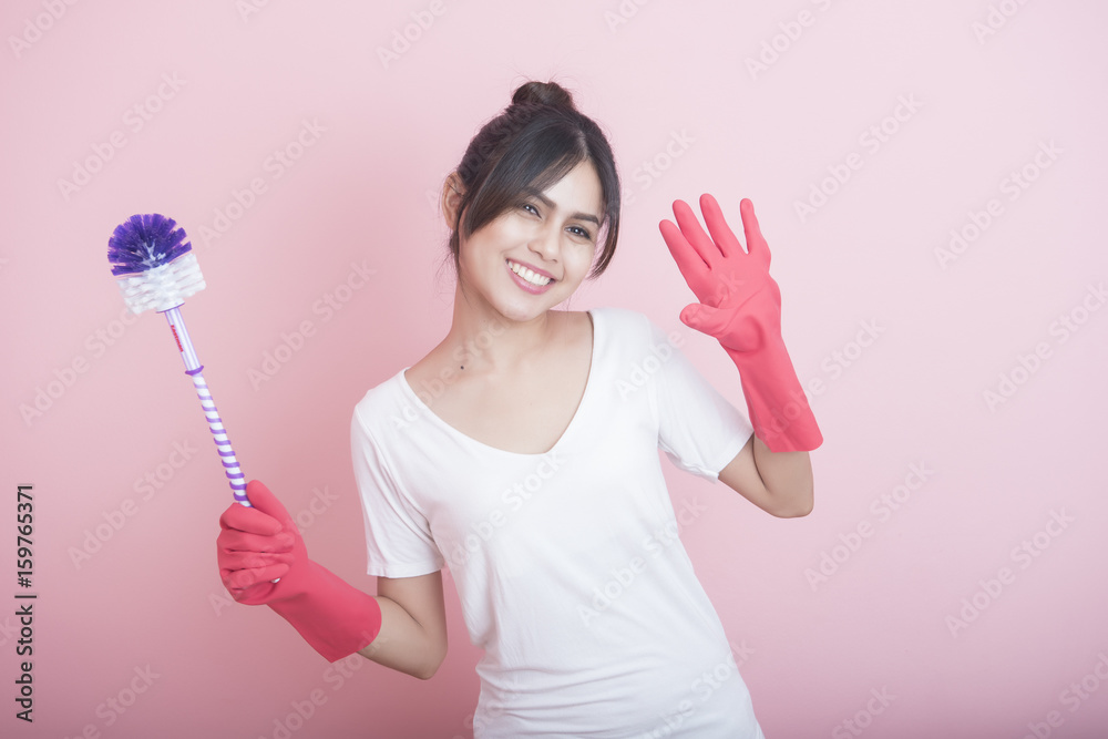 Beautiful asian housewife smiling on pink background Beautiful asian housewife smiling on pink background