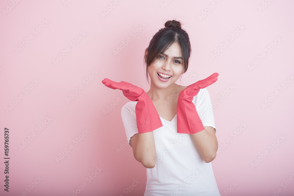 Beautiful asian housewife smiling on pink background Beautiful asian housewife smiling on pink background