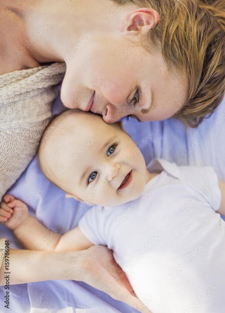 Mother lying down with baby boy (6-11 months) Mother lying down with baby boy (6-11 months)