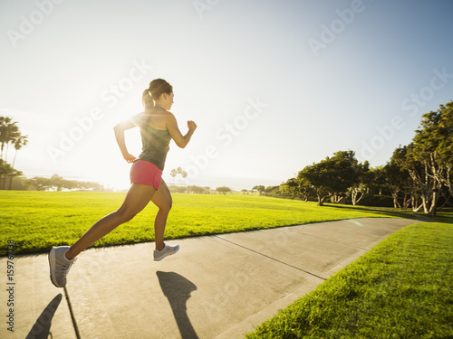 Young woman running in park photo