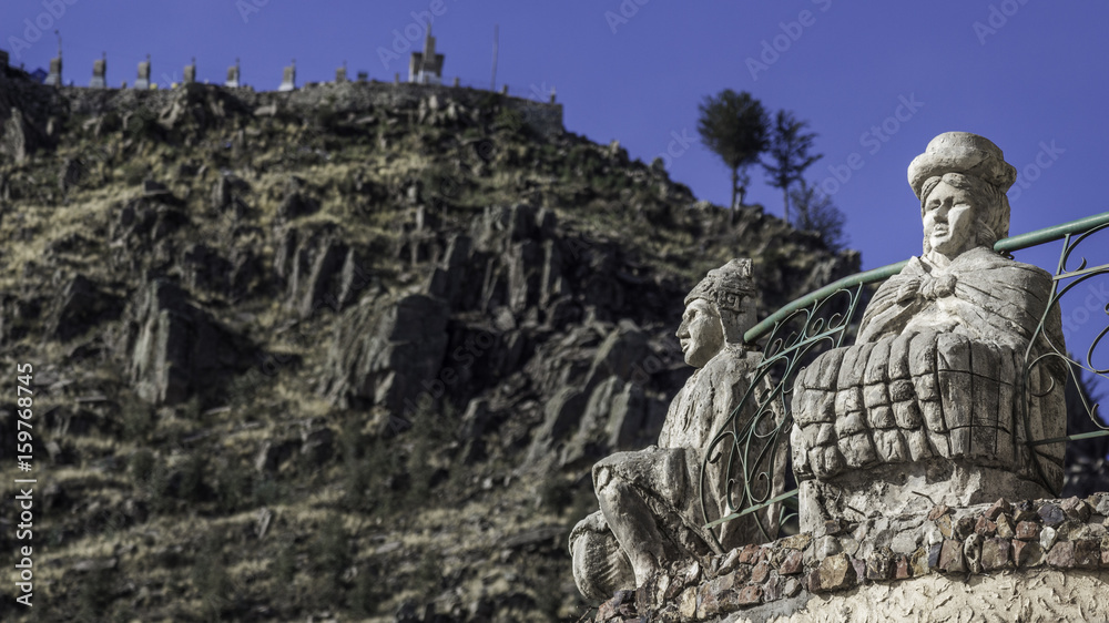 Two folk statues with the monte Calvario in Copacabana (Bolivia)