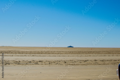 very big sand space with a blue background sky