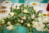 bouquet of white roses in the decoration of the festive table